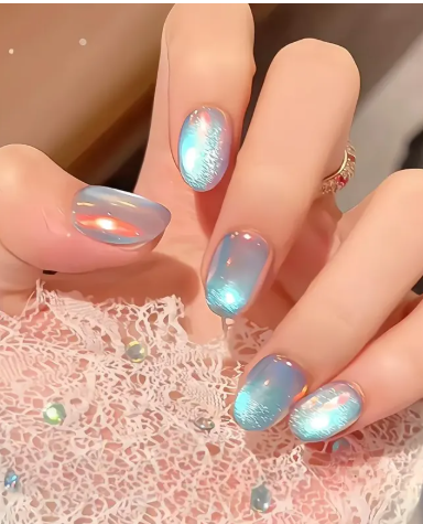 Close-up of a hand with iridescent blue and pink nails holding lace fabric decorated with small reflective embellishments.