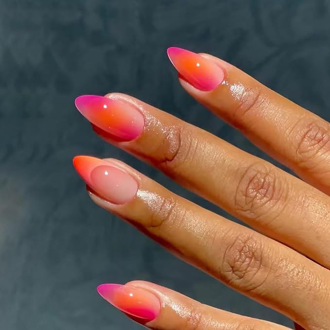 Bright orange and pink vacation nails with tropical flair and glossy finish.


