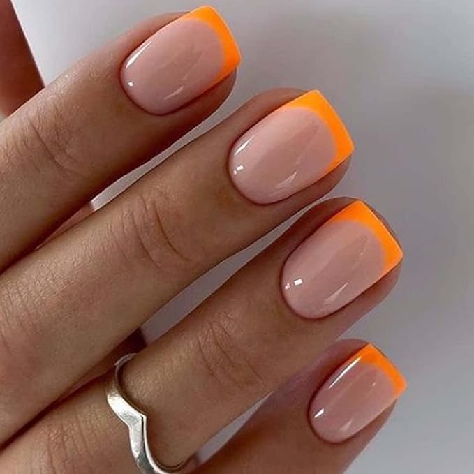 Gradient ombré French manicure in vibrant pink and orange tones, perfect for summer 2025.

