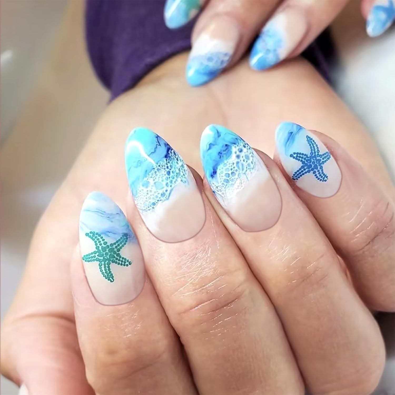 Ocean-inspired nail art with seafoam blues, sandy neutrals, and wave-like swirls.

