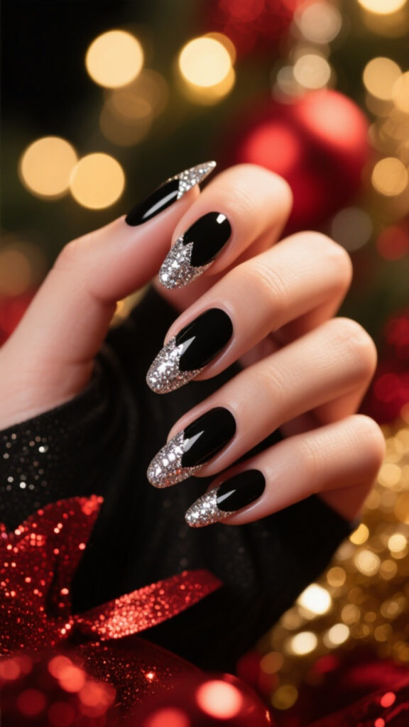 Black nails with silver glitter French tips, festive black and silver nail design for parties.